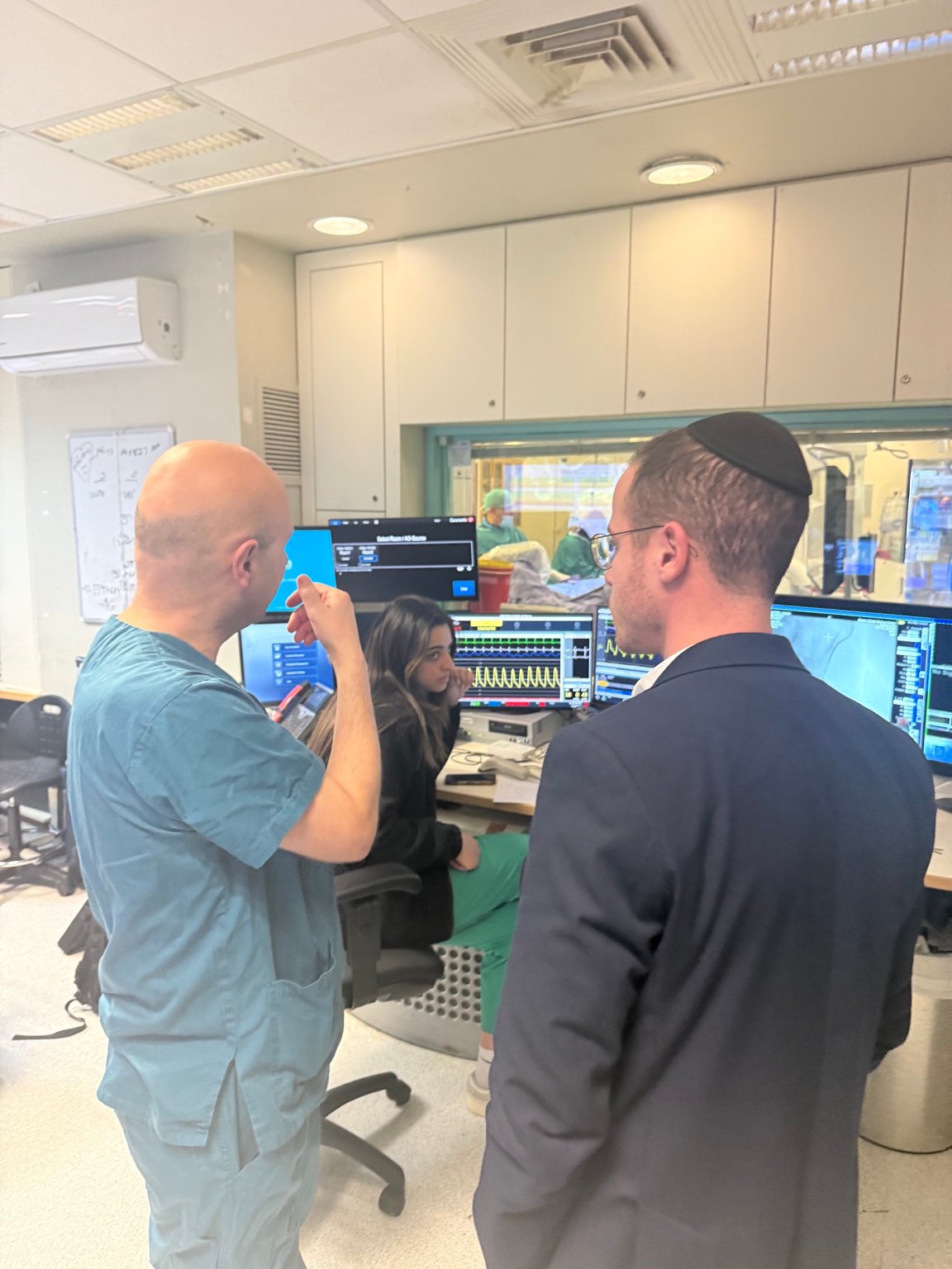 The Mazor team consulting with medical staff